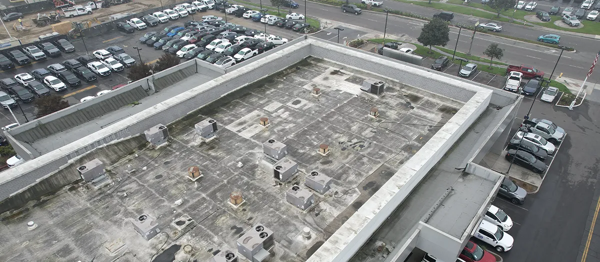 Weathered commercial building roof in need of repairs